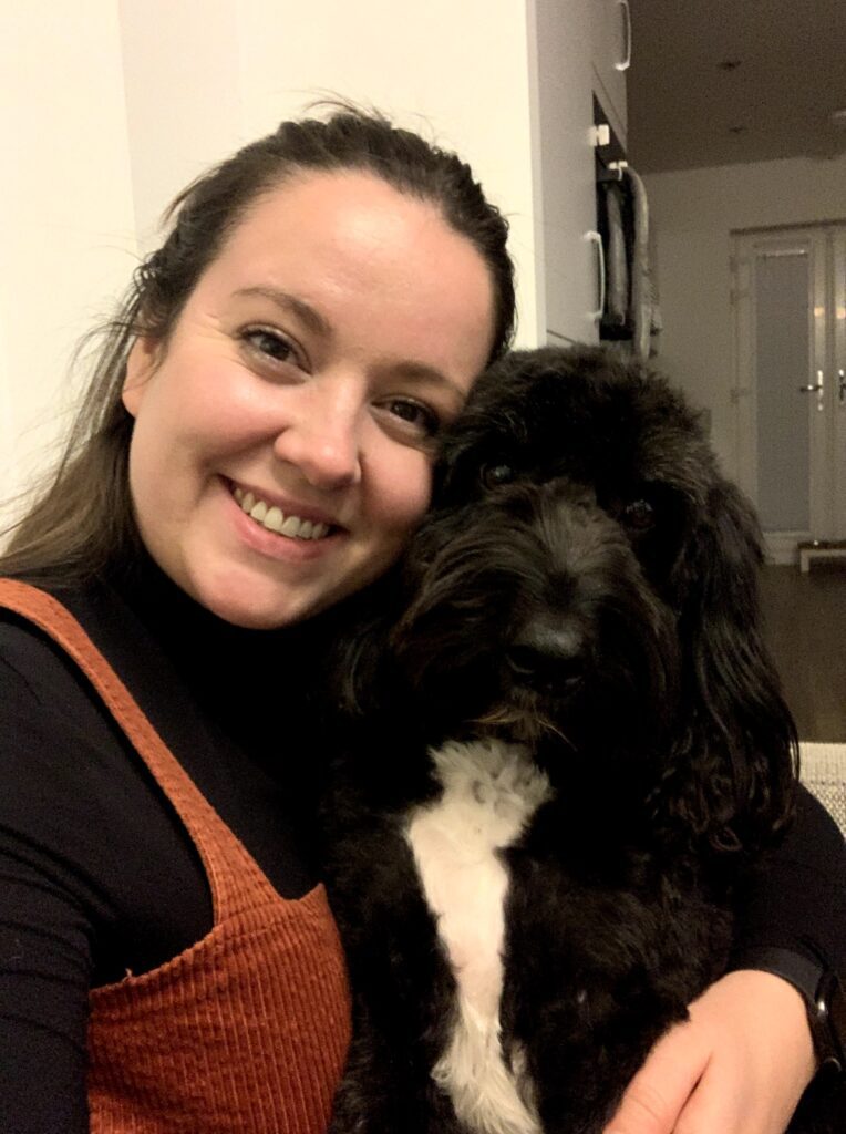 Rachael from Adventures by April Gold with her black cockapoo, Baxter